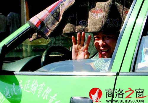 看到记者采访，旁边的出租车司机热心地打了个招呼。