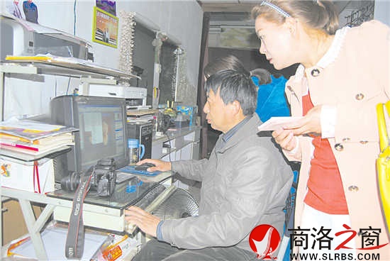 康铁成正在为顾客处理照片