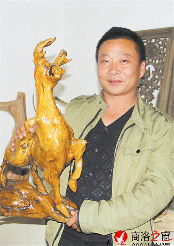 程家驹向记者介绍他的根雕